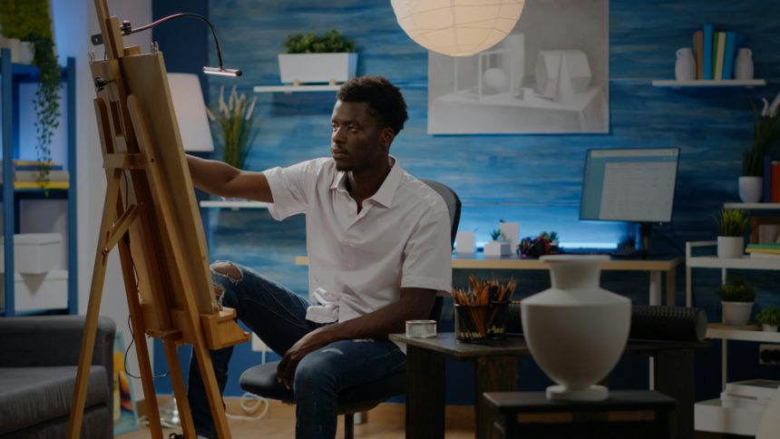 African american creative man using vase for drawing inspiration