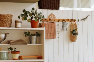 Houseplants and decorative baskets on shelving in interior design