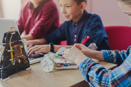 Stem education. Kids creating robots at school