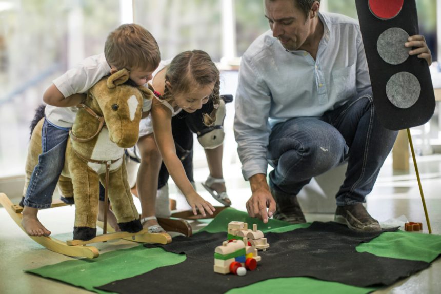 Teacher teaching road safety rules to children